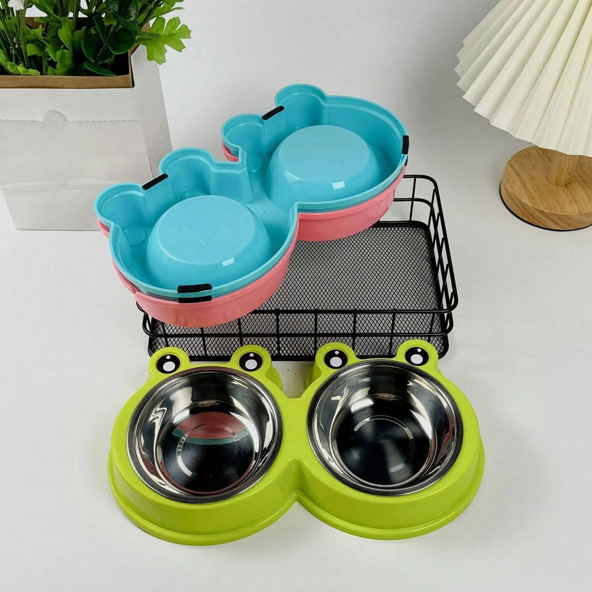Green double pet bowl with stainless steel bowls on a white background, Pet product